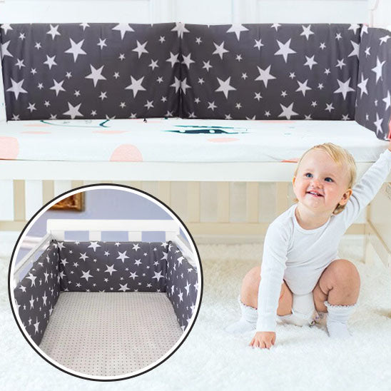 fillette assise berceau admire tour de lit bebe bleu fonce etoiles